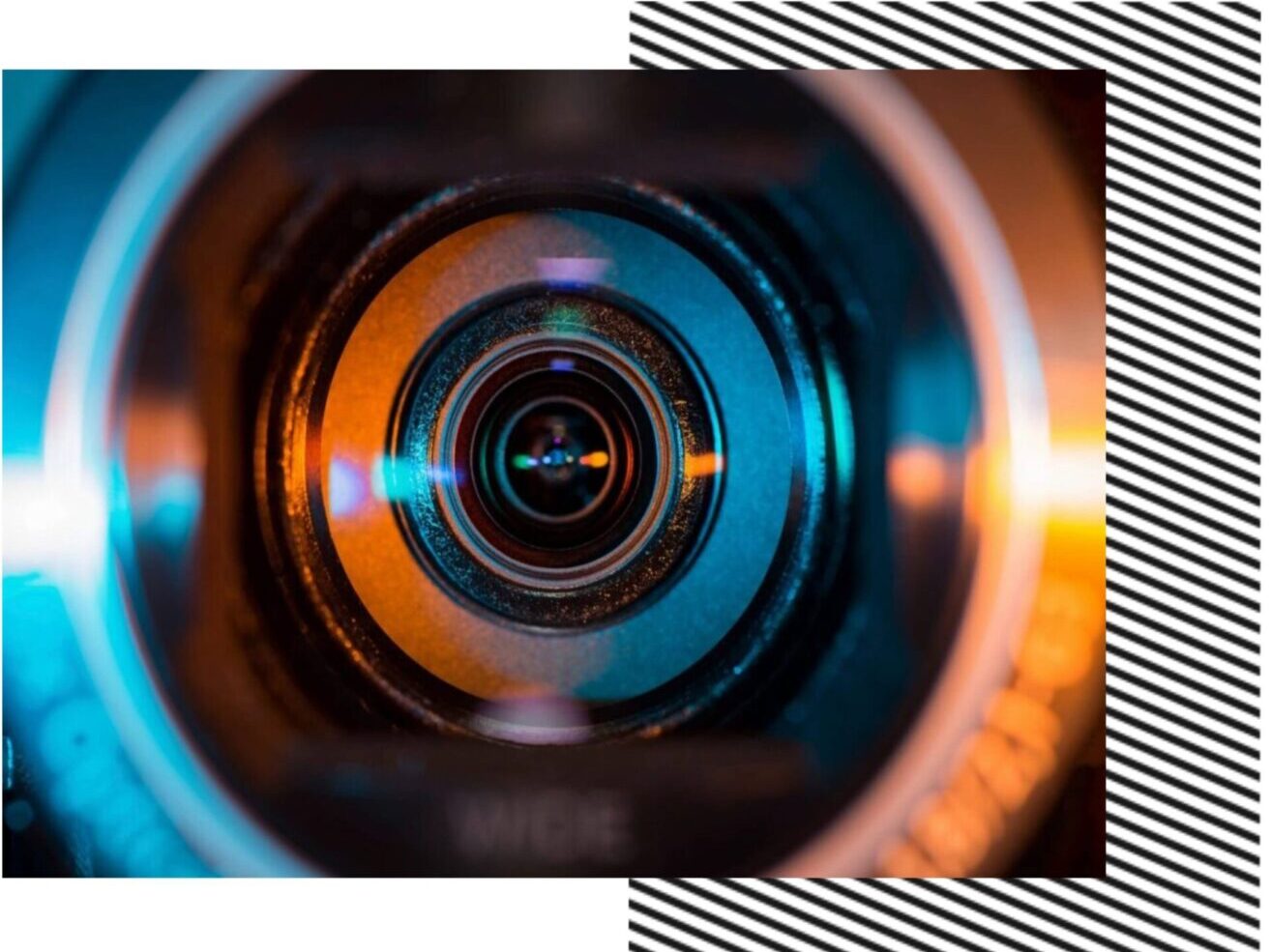 A close up of the camera lens with an orange and blue reflection.